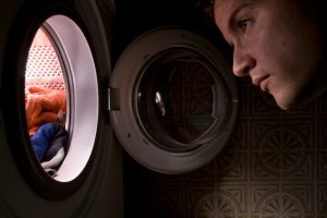 Man Looking inside the washing machine
