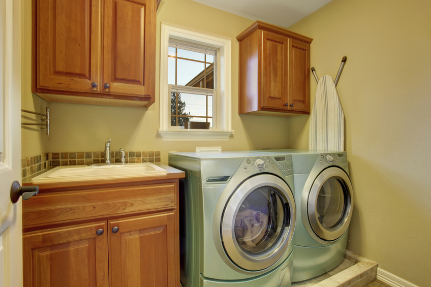 simple laundry room with tile floor and appliances.