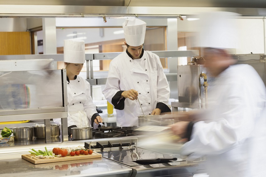 Busy chefs at work in the restaurant kitchen