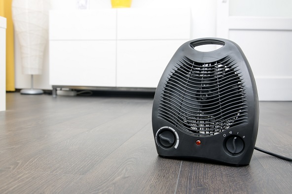 black electric heater on laminate floor in the room